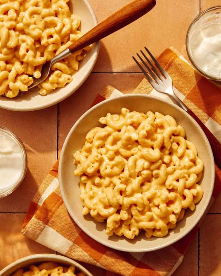 Three bowls of mac and cheese made in a crock pot.