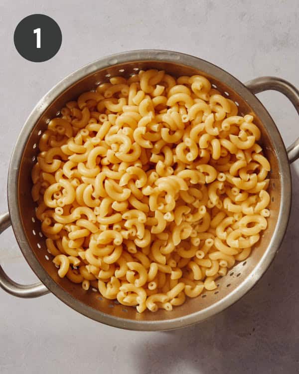 Freshly cooked elbow macaroni in a colander.