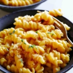 Pumpkin mac and cheese recipe in two bowls.
