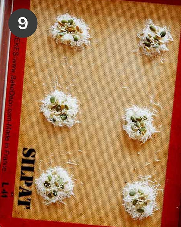 Parmesan and seeds on a baking sheet to make Parmesan Crisps.