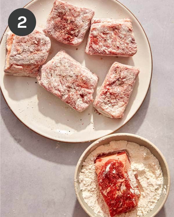 Short ribs being coated in flour.