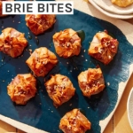 A brie appetizer recipe on a platter with plates on the side for serving.