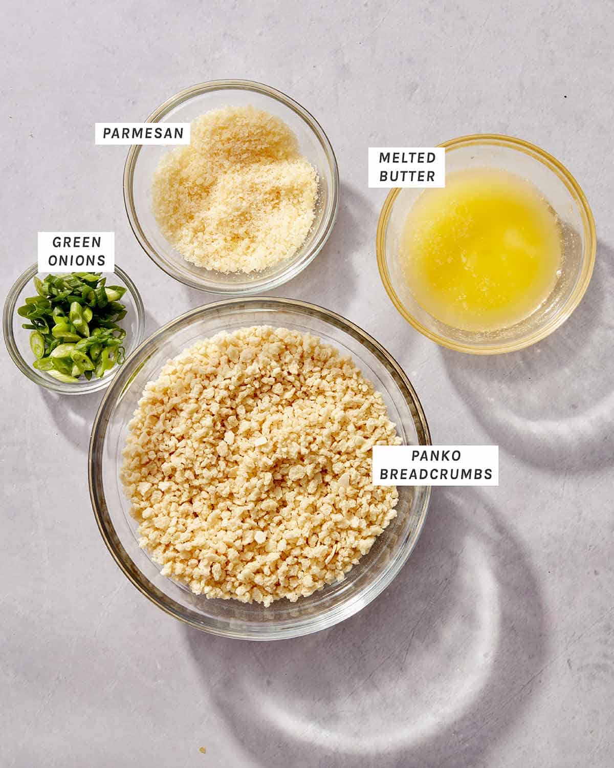 Jalapeño popper dip topping ingredients laid out on a kitchen table.