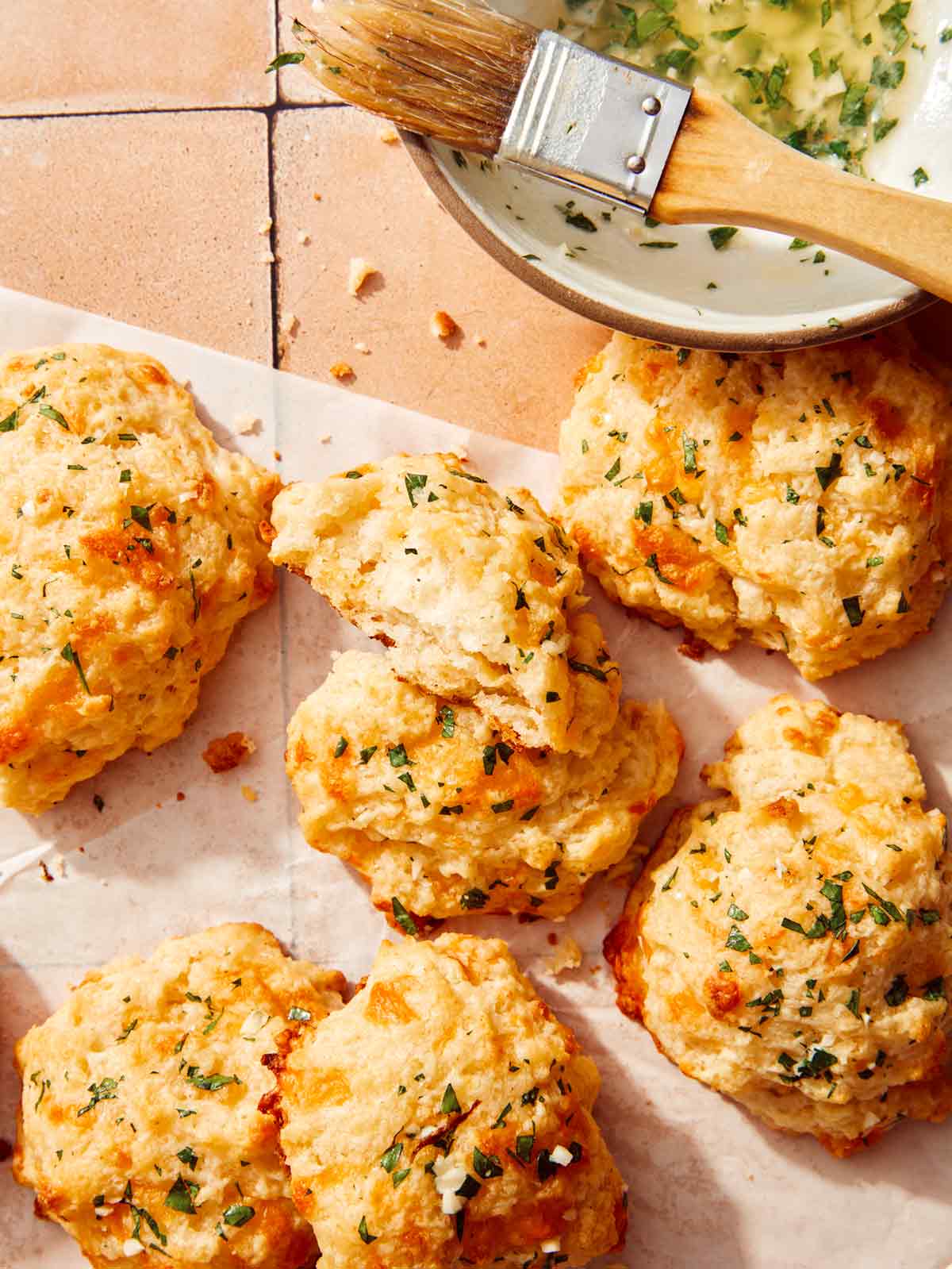 Up close on cheddar bay biscuits with one tore open.
