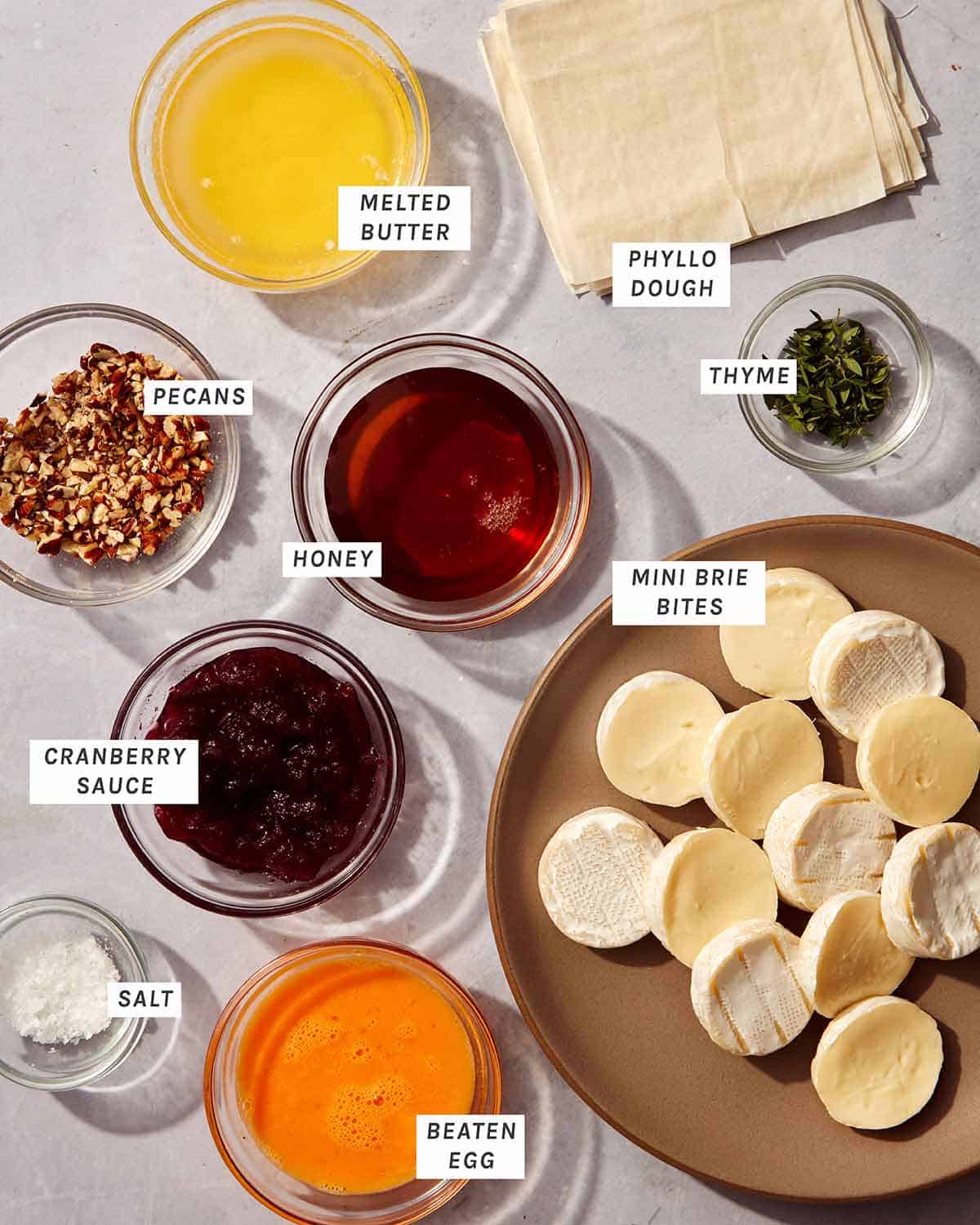 Cranberry brie bites ingredients on a kitchen counter. 
