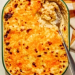 Easy baked mac and cheese in a dish with a spoon in it.