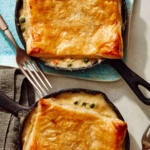 Freshly baked chicken pot pies in skillets.