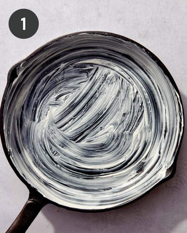 A cast iron skillet with rubbed with butter.