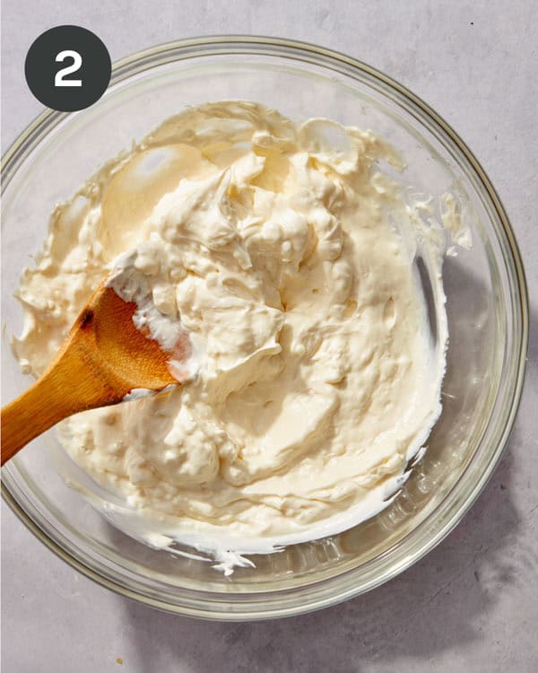 The base mixture of Jalapeño popper dip on a glass bowl mixed together.