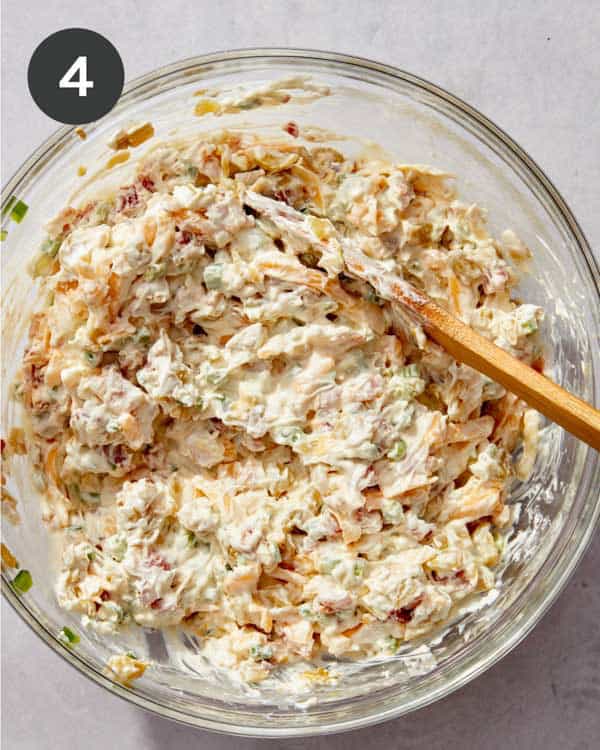 Jalapeño popper dip mixed together in a glass bowl.