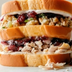 A huge leftover Thanksgiving Sandwich built and ready to be eaten.