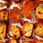 Parmesan crusted crostini in a baking dish.