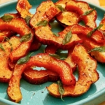 Roasted acorn squash recipe on a plate.