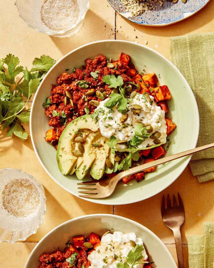 Beef protein bowl with a fork on the side and some cilantro.