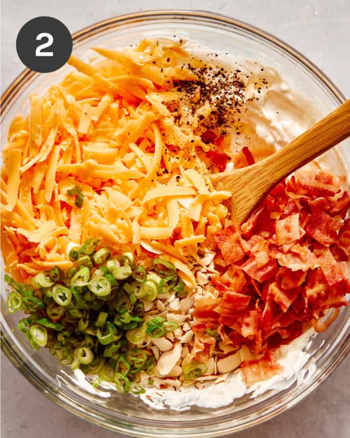 Ingredients for million dollar dip in a bowl about to be mixed.