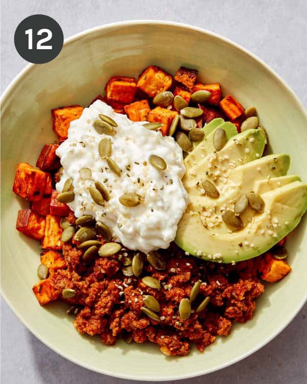 A protein bowl with some nuts on top.