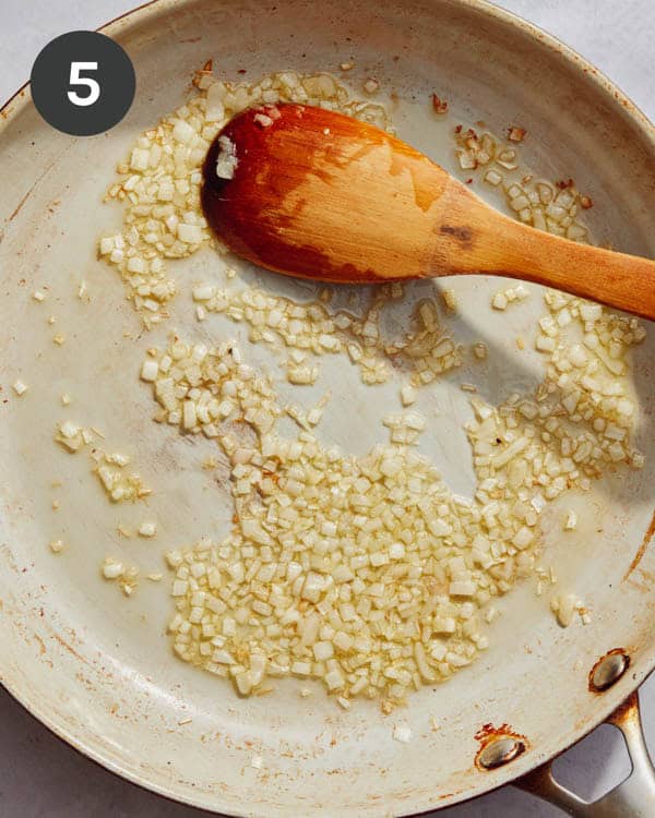 Shallots cooking in a skillet.