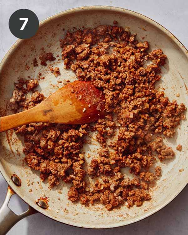 Seasoned ground beef cooking in a skillet.