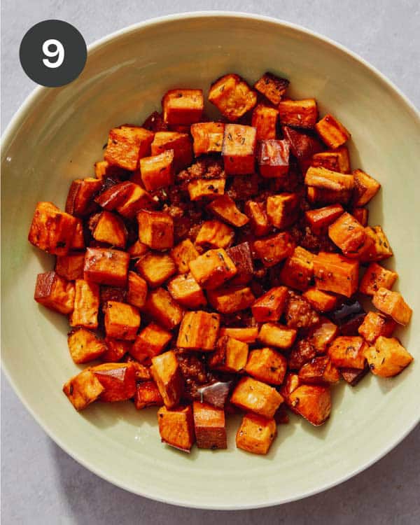 A bowl full of roasted sweet potatoes.