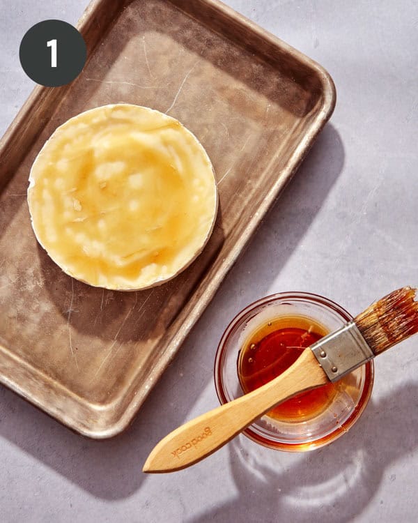 A wheel of brie brushed with honey.