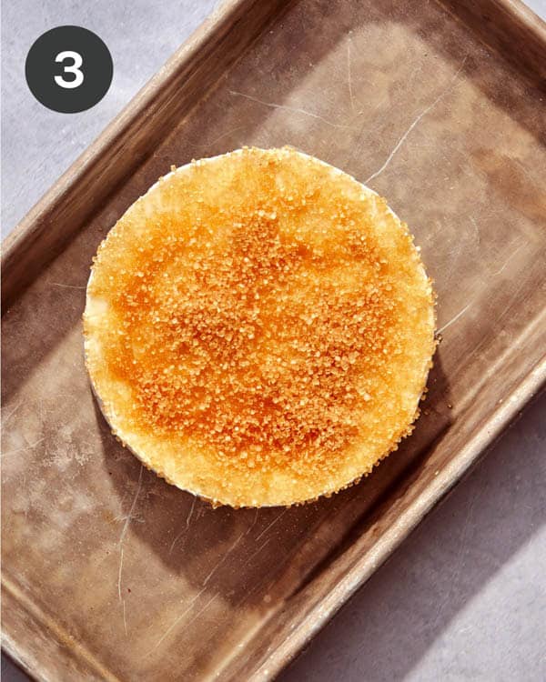 A wheel of brie with honey and sugar.