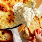 Baked garlic bread dip in a skillet.