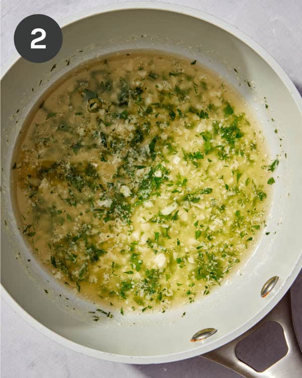 A garlic butter and heb mixture in a skillet.