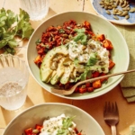 Beef protein bowls on a kitchen counter with water on the side.