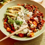 A beef protein bowl with some bites taken out and a fork in it.