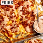 Animal style fries on a baking sheet.