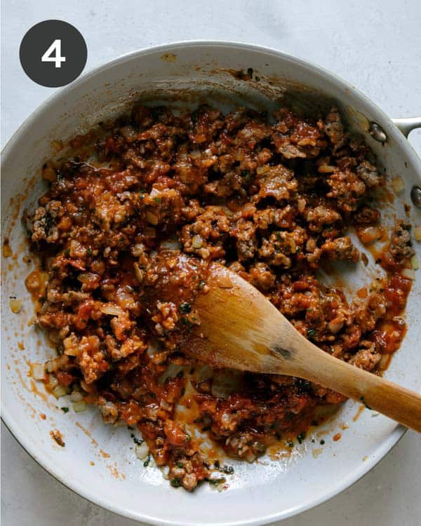 Turkey sausage with marinara sauce in a skillet. 