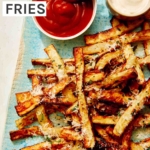 Air fryer french fries on a platter with ketchup and mayo.
