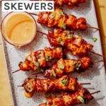 Air fryer bang bang chicken skewers with dipping sauce.