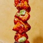 Close up on one air fryer bang bang chicken skewer.