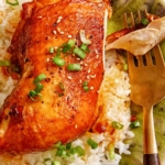 Braised garlic and ginger chicken with a piece on a fork.