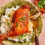 Braised garlic and ginger chicken with a piece on a fork.