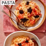 Smoked salmon pasta in two bowls with forks on the side.