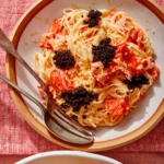 Smoked salmon pasta in two bowls with forks on the side.
