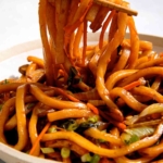 Yaki udon noodle recipe in a bowl with chopsticks.