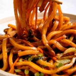 Yaki udon noodle recipe in a bowl with chopsticks.
