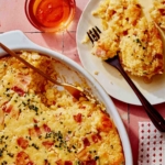 Corn casserole recipe with some scooped out on a plate.