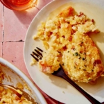 Corn casserole on a plate with a fork.