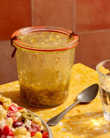 Italian vinaigrette recipe on a table in a jar.