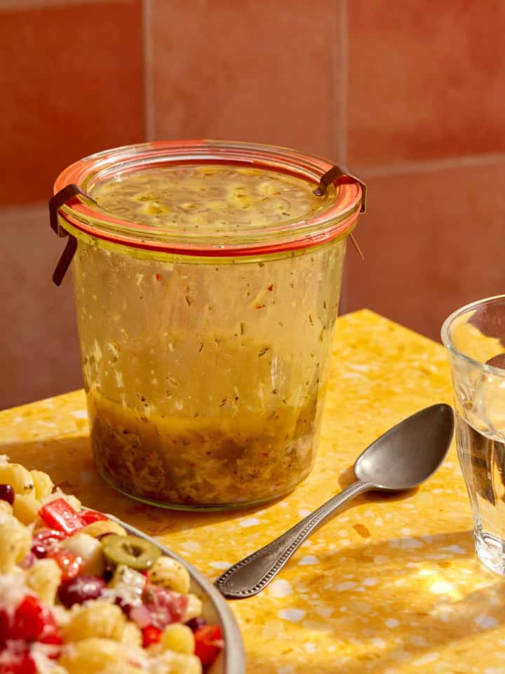 Italian vinaigrette recipe on a table in a jar.