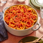 Lasagna roll ups in a baking dish about to be served.