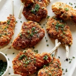 Panko crusted lamb chops on a plate.
