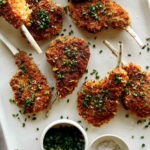 Panko crusted lamb chops on a plate.