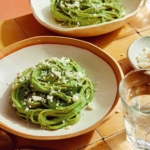 Tallarines Verde pasta dish in two bowls ready to be served.