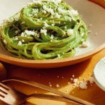 Tallarines Verde recipe in a bowl close up with some queso fresco sprinkled on top.