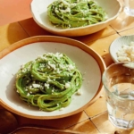 Tallarines Verde pasta dish in two bowls ready to be served.